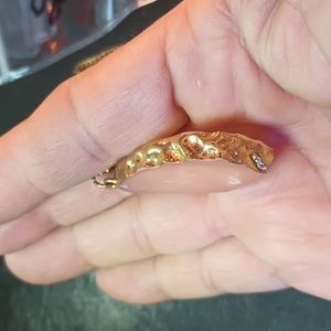 Necklace with peach Stone gold trim surrounding it on a golden long necklace 14